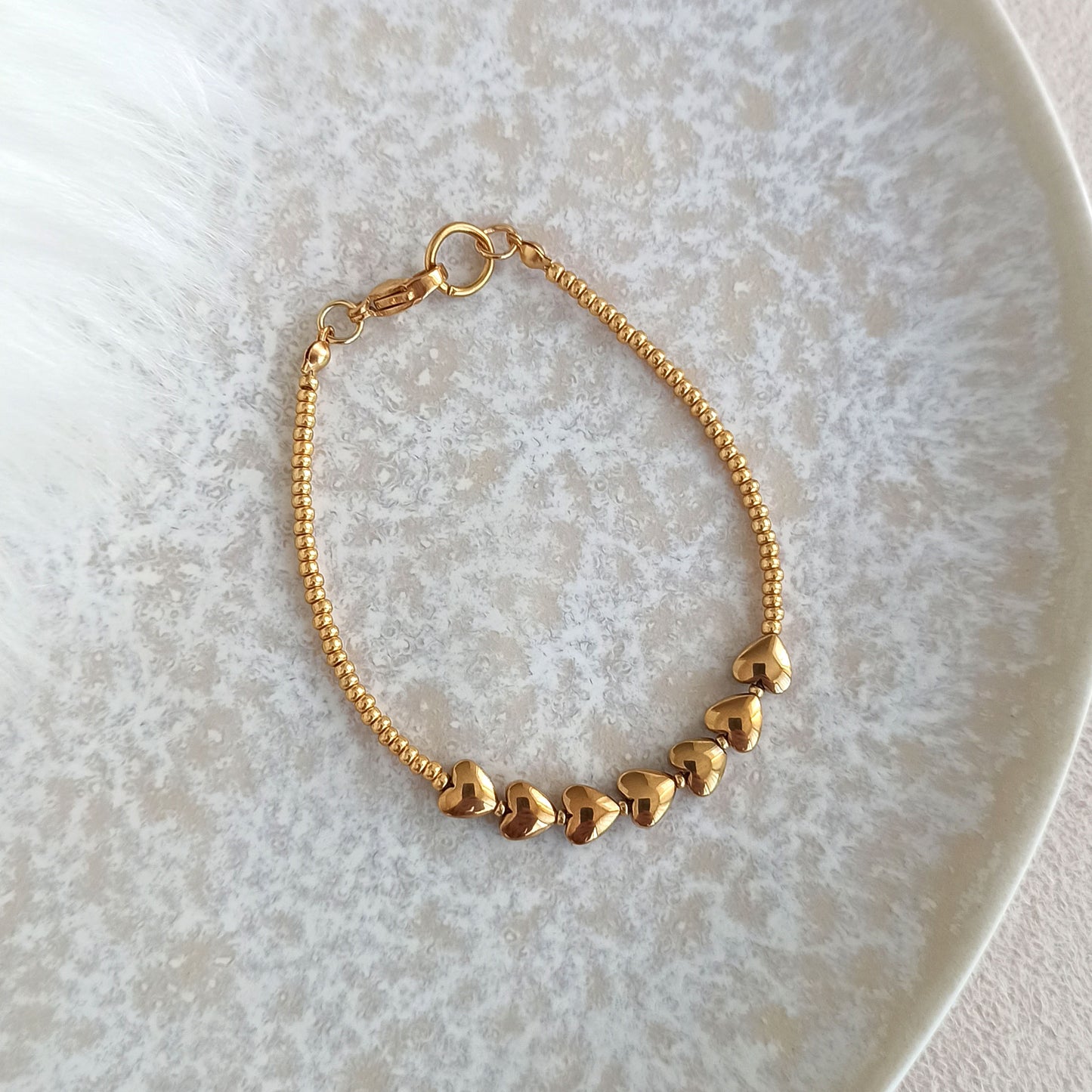 Náramek s pozlacenými srdíčky a rokajlem